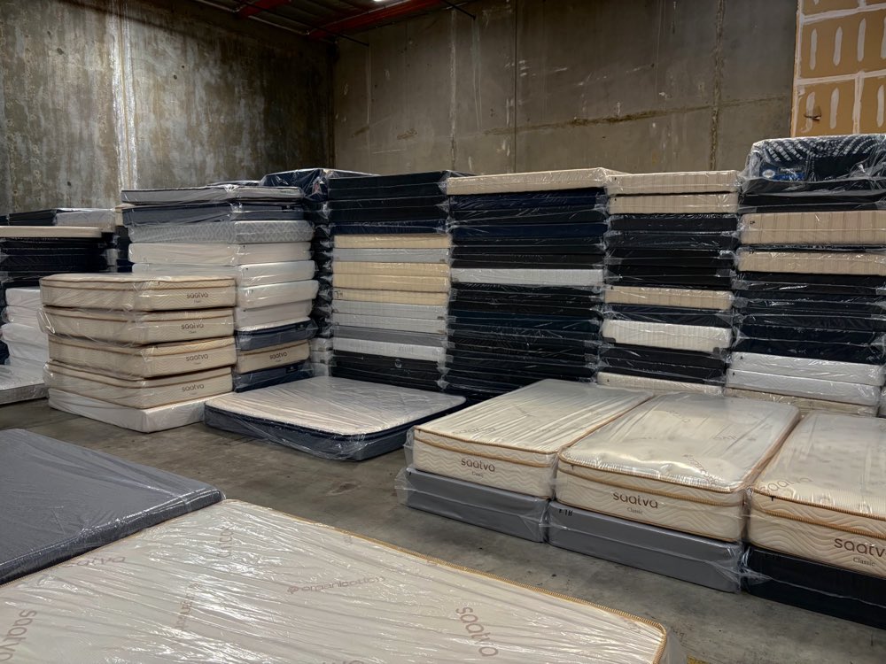 Stacks of Saatva and Beautyrest mattresses in stock at Mattress Liquidation in Rancho Cucamonga