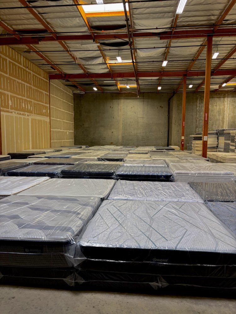 Queen and king mattress sets lined up across the showroom floor at Mattress Liquidation in Rancho Cucamonga